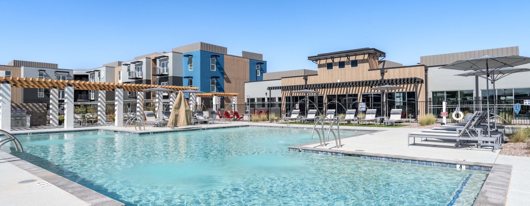 resort style pool with seating and a building behind