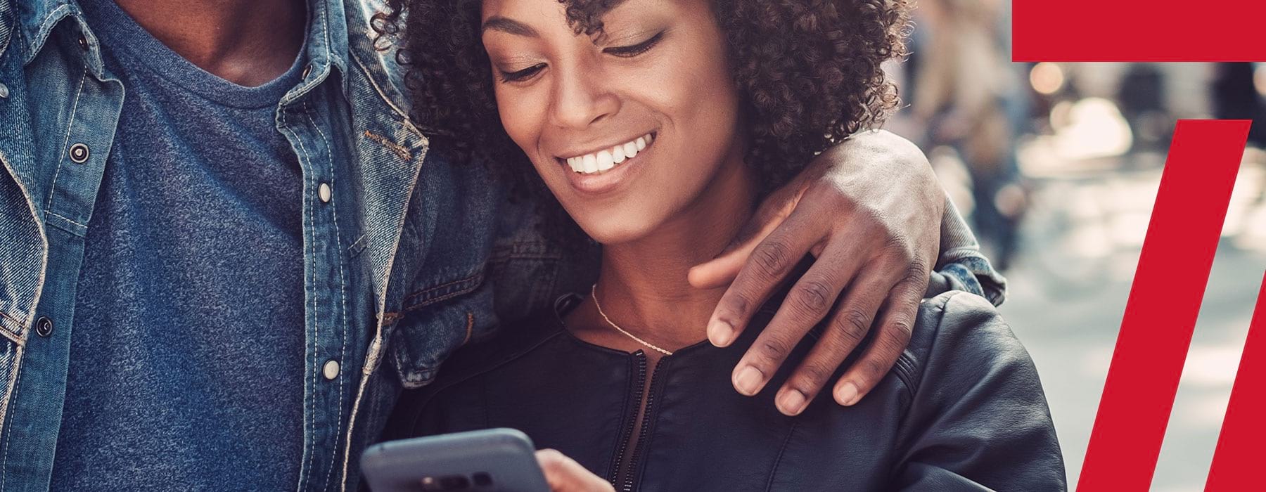 lifestyle image of a woman smiling while looking at her device