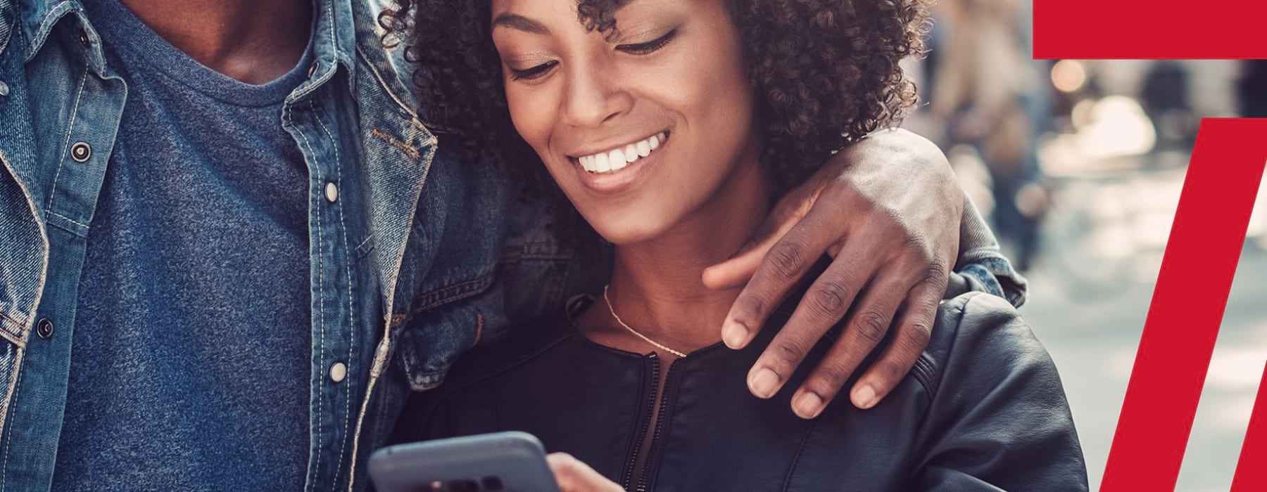 lifestyle image of a woman smiling while looking at her device