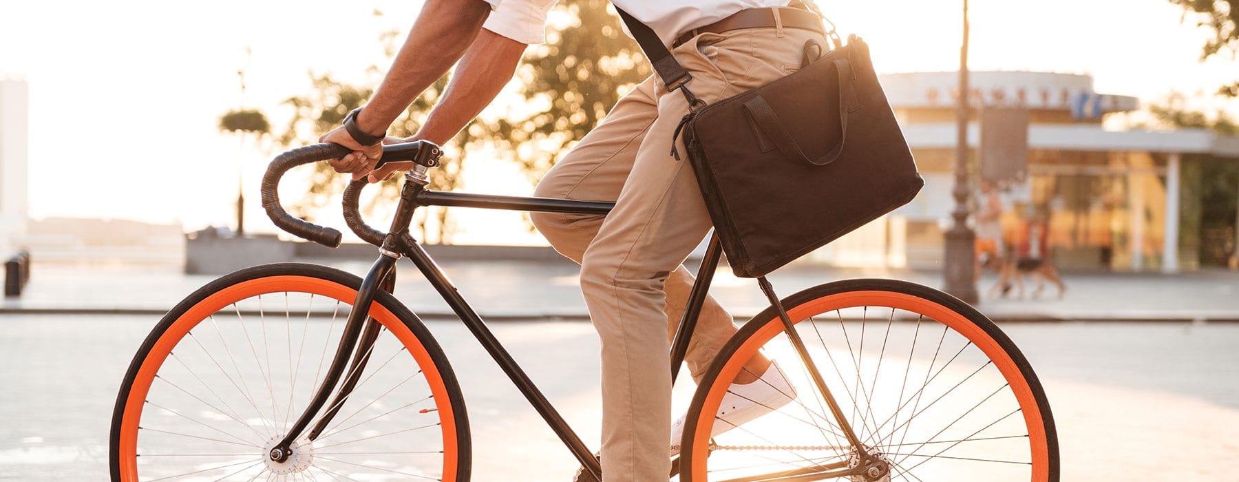 lifestyle image of a person riding their bicycle at a sunset
