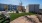 The grounds at our apartments for rent in Midland, TX, featuring a lawn, chairs, and cars parked in the background.