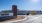 The entrance to the FLATZ 432 apartment complex in Midland, TX, featuring a sign and cars parked in the parking lot.