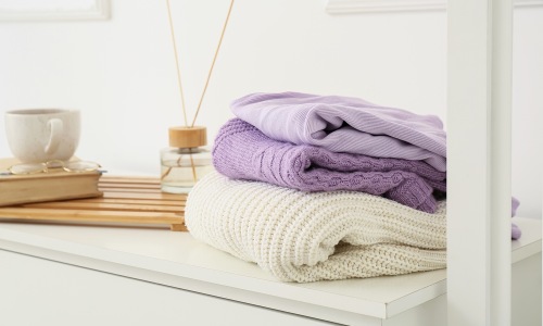 Folded clothes on top of dresser